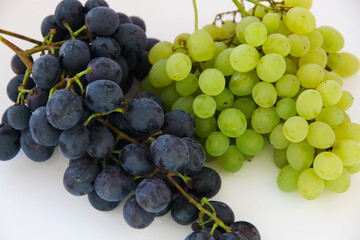 Green grapes . Large bunch of fresh fruit with green leaves and white backgrounds