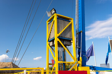 The catapult tensioning mechanism made of many springs and hydraulic cylinders against the blue sky.