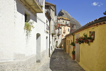 A narrow street among the old houses of Castelmezzano, a rural village in the Basilicata region, Italy.