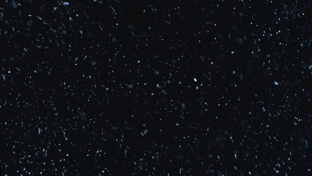 Christmas VFX insert element. 40 seconds of a snowstorm. Natural snow falling isolated on black. Swirling snowflakes weather element. Ethereal, Intense, Storm. Snowing dream.
