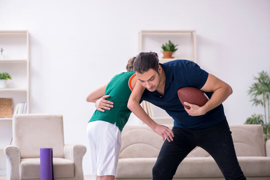Father and son doing sport exercises indoors