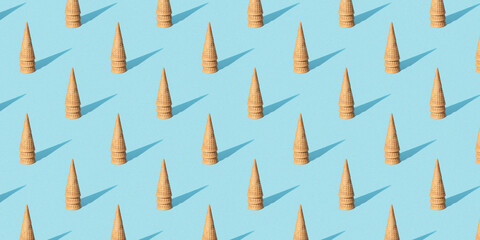 Christmas seamless pattern with ice cream cons as a Christmas trees on light blue background