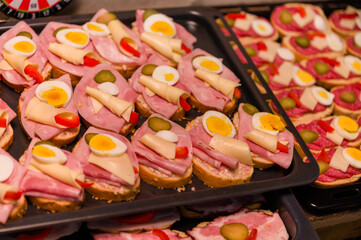 Handmade sandwiches with salami, cheese and egg.
