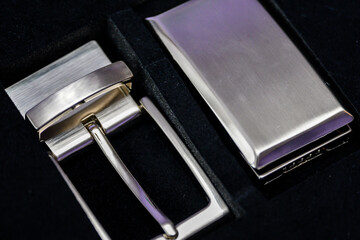 Shiny metal buckle and leather belt in a gift set.

