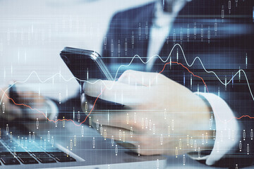 Multi exposure of man's hands holding and using a digital phone and forex graph drawing. Financial market concept.