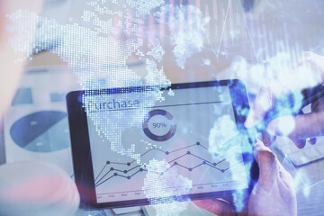 Double exposure of man's hands holding and using a phone and financial chart drawing. Market analysis concept.