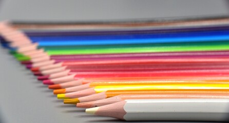 Palette of colored pencils in order towards the bottom.