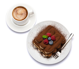 portion of Classic tiramisu dessert with raspberries, blueberries and cup of fresh hot espresso isolated on white background - clipping path