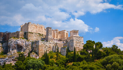 Fototapeta na wymiar View of Acropolis hill from Areopagus hill on summer day with great clouds in blue sky, Athens, Greece. UNESCO heritage. Propylaea gate, Parthenon.