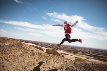 Woman trail runner cross country running  on sand desert dunes