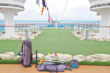 Mini golf putting green field onboard luxury cruise ship or cruiseship liner	
