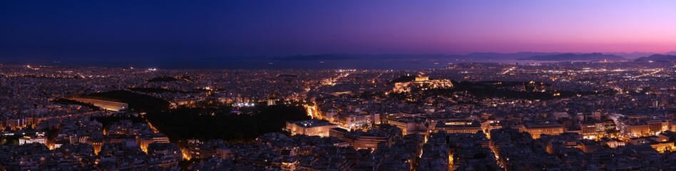 Fototapeta na wymiar Panorama of Athens and Saronic Gulf on Lycabettus hill at dusk. Acropolis, Parthenon, Hellenic Parliament, Syntagma, Olympic stadium of Kallimarmaro.