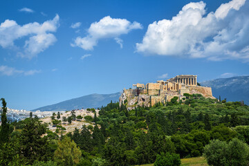 Fototapeta na wymiar Great view of Acropolis hill from Pnyx hill on summer day with great clouds in blue sky, Athens, Greece. UNESCO world heritage. Propylaea, Parthenon.