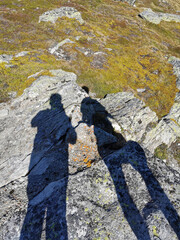 silhouette of tow photographers on rocks in Swiss alps. Copy space
