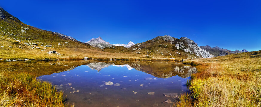 panorama scenery of the swiss alps. Lake at the top of grimsel p