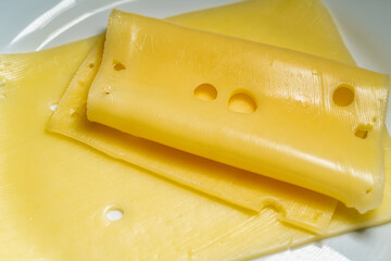 Sliced delicious cheese on on a white plate