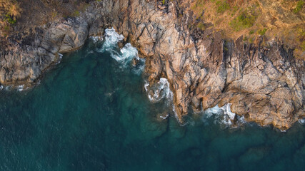 Aerial view. Top view of turquoise sea water washes the rocky shore. Landscape background. Thailand, Phuket