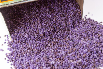 Purple mineral fertilizer for the lawn in the garden isolated on white background