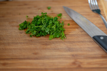 fresh, green, chopped parsley on a kitchen table board