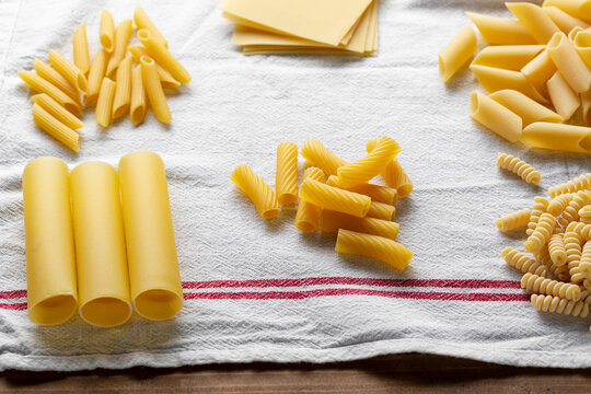 Raw pasta set on kitchen towel