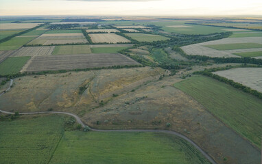 View of the fields and gardens from above. Sunset sky.