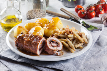 Pork rolls stuffed with vegetables served with potatoes