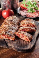 Italian stromboli stuffed with ham, salami and cheese