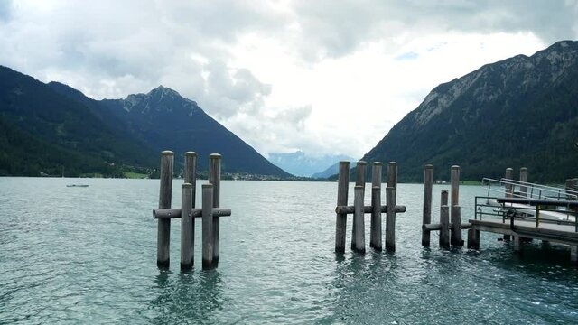Beautiful Achensee lake near pier for ships during holiday vacation in Austria.Static wide shot.