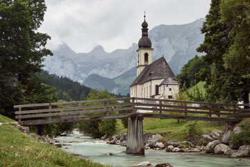 Fototapeta na wymiar St. Sebastian church and mountain creek in front of the Berchtesgaden Alps in Ramsau, Germany