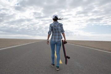 Asian woman skateboarder skateboarding in the wide world