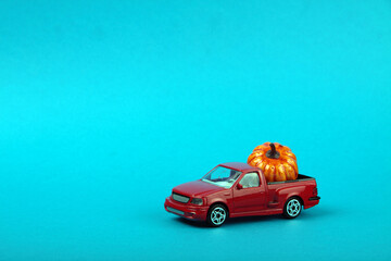 pumpkin on red pickup isolated on blue background