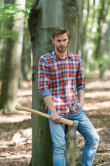 relax after work. spend picnic weekend in forest. man ready for splitting wood and cutting firewood with axe. prepare to chop down tree. chopping and splitting firewood with ax. lumber worker in wood