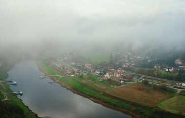 beautiful top view of the river and the village through the clouds in the morning