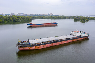 Top view of a cargo ship carrying grain. Anchored in the water area of the city of Dnepropetrovsk. River transport on the Dnieper river