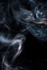 White smoke from incense stick isolated against dark background
