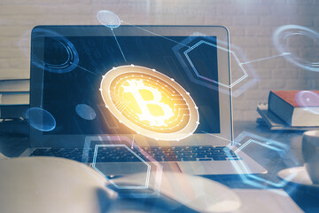 Multi exposure of blockchain theme hologram and table with computer background. Concept of bitcoin...