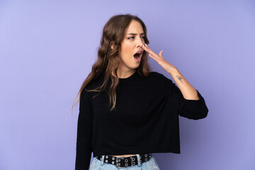 Young woman over isolated purple background yawning and covering wide open mouth with hand