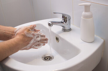 Coronavirus pandemic prevention wash hands with soap warm water and , rubbing nails and fingers washing frequently or using hand sanitizer gel.