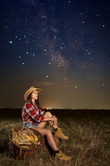 Farmer woman with her basket under starry sky