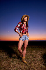 Young cowgirl at sunset