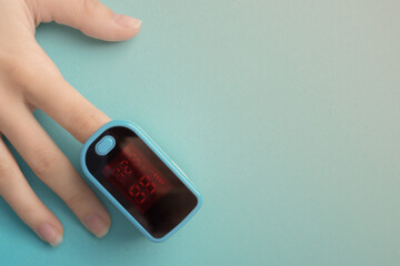 Diagnosis of diseases of the respiratory system with a pulse oximeter on a blue background