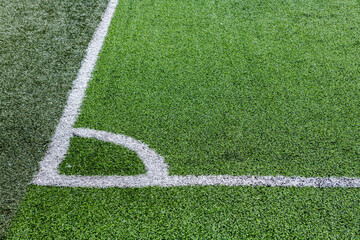 Obraz premium Nice close up shot of green artificial grass football pitch with corner markings 
