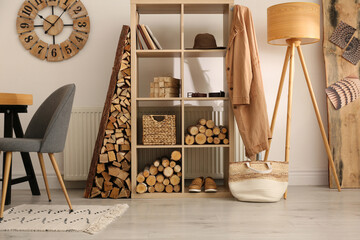 Stylish room interior with firewood as decorative element