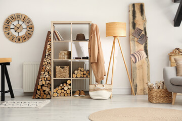 Naklejka premium Stylish room interior with firewood as decorative element