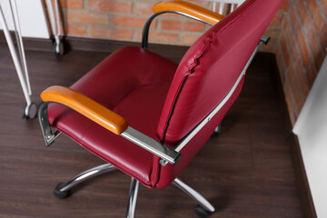 Comfortable red desk chair in modern office, closeup