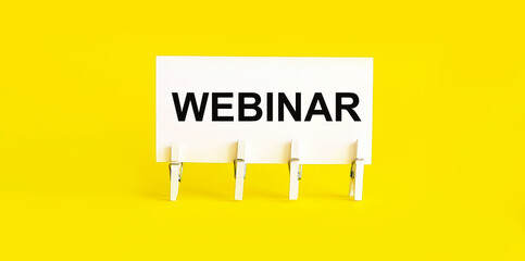 text WEBINAR on white short note paper yellow background