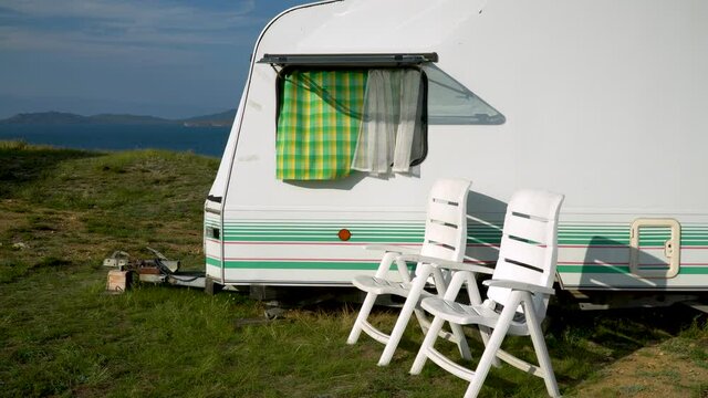 tourist trailer on the shore of a beautiful lake. caravan trailer of large size, equipped with all necessary household appliances to ensure the comfort of the traveler