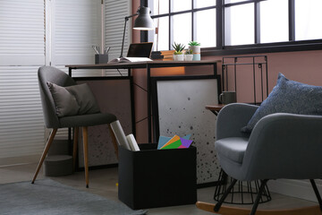 Stylish room interior with comfortable workplace near window