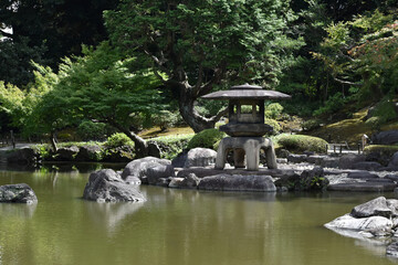 巨大な石灯籠と池のある日本庭園の風景（旧古河庭園）