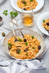 spaghetti in creamy tomato sauce with olives